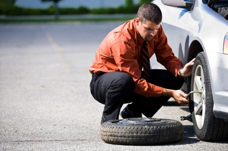 Man changing a flat tire